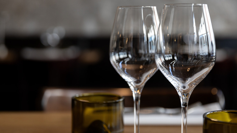 Two empty wine glasses sitting on a table.