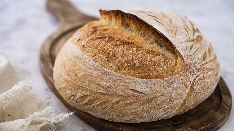 Sourdough loaf on wooden cutting board