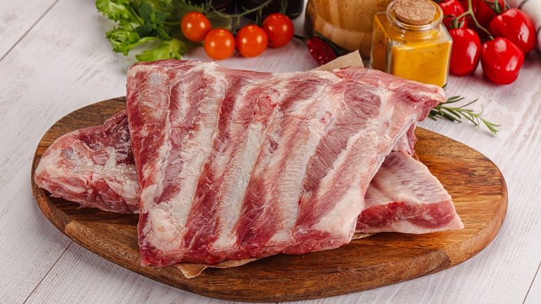 Raw pork ribs on wood board