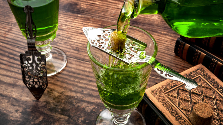 Absinthe pouring over sugar cube