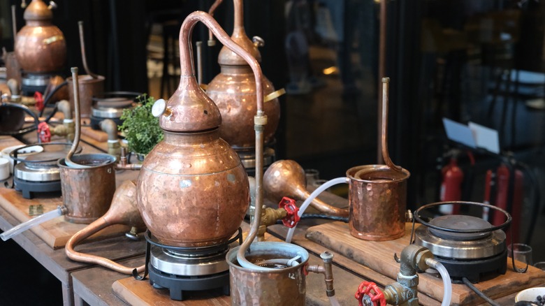 Brass moonshine still on wood table