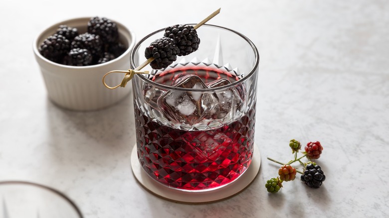 Cocktail garnished with blackberries