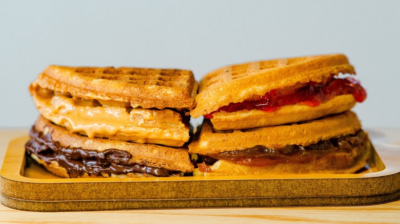 stack of four folded waffles with a variety of spreads inside