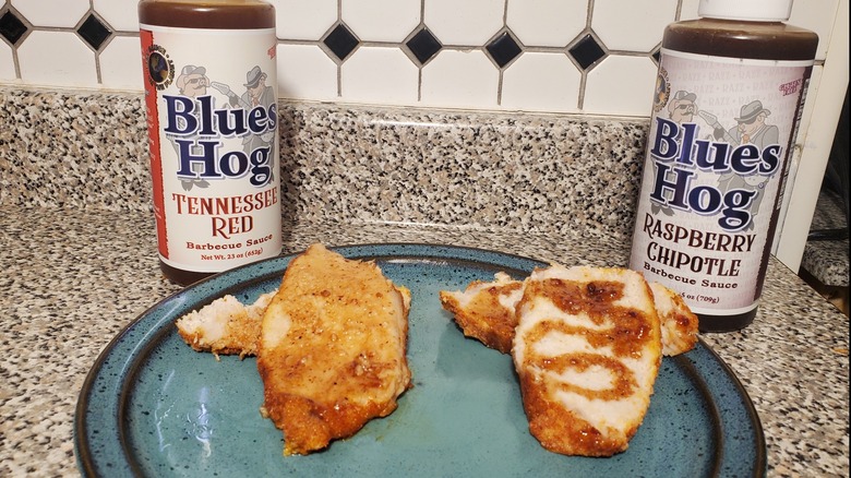 Blues Hog Tennessee Red and Raspberry Chipotle barbecue sauces on slices of pork loin