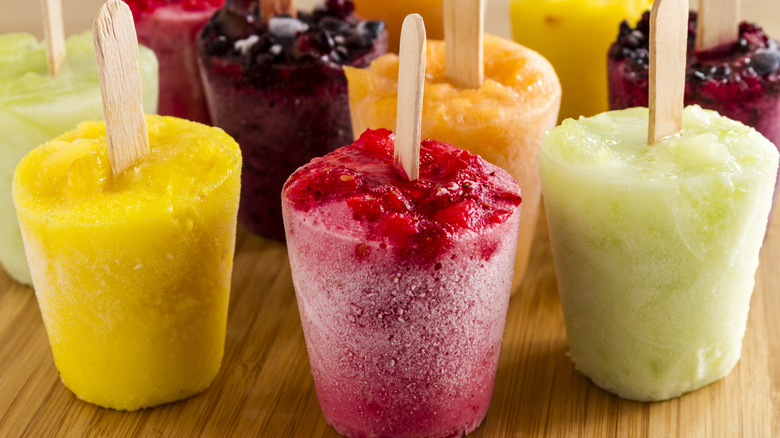 Assorted popsicles on wooden surface