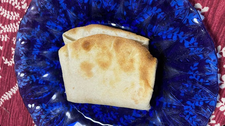 Quesadilla on blue plate maroon tablecloth