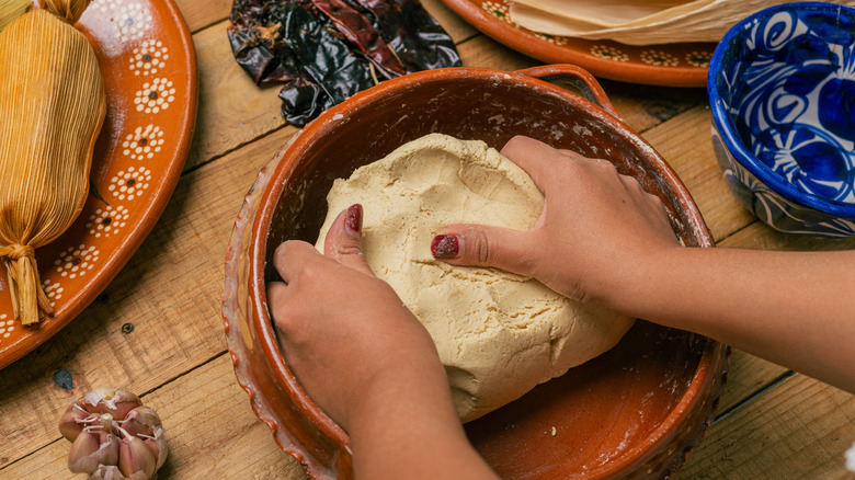 Kneading corn flour dough (masa harina) to make tortillas