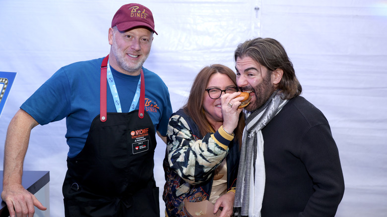 Rachael Ray feeding burger to her husband