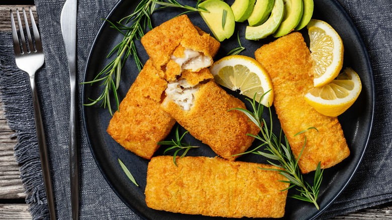 Battered Alaskan pollock fillets served on a plate.