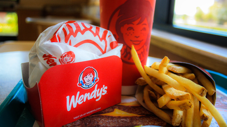 A Wendy's to-go meal with fries and a drink.