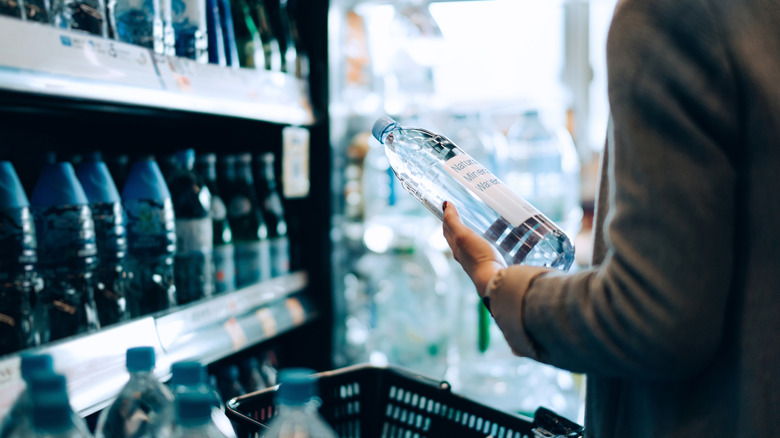 Person holding bottle of water