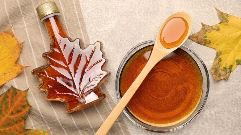 Maple syrup in glass jar and bowl