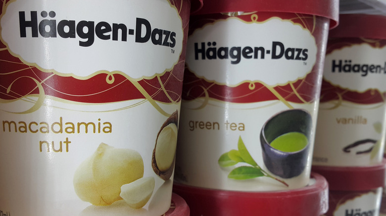 Haagen-Daz ice cream pints, flavored macadamia nut, green tea, and vanilla, close up.