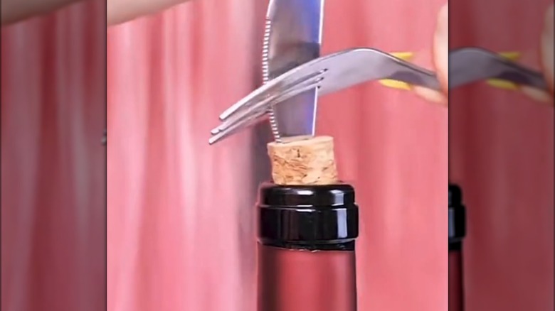 Using fork and knife to unscrew cork