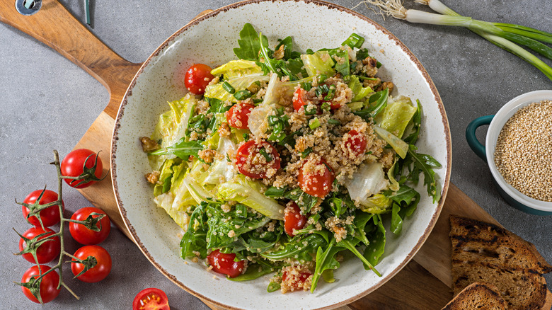 Quinoa sprinkled on tomato lettuce salad