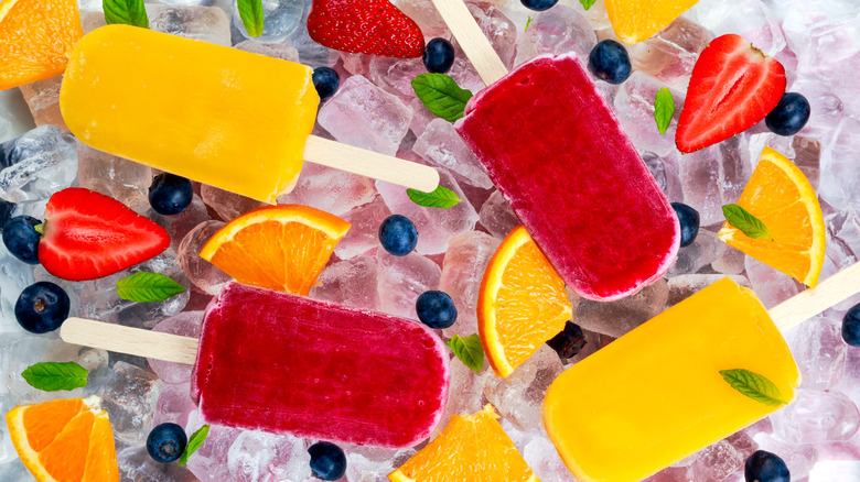 Popsicles over ice and fruits