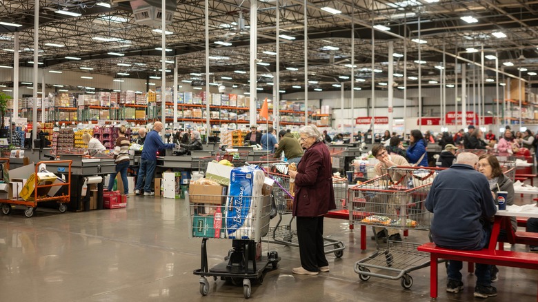 people shopping inside a large and busy costco