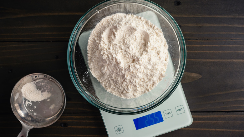 Weighing flour on a kitchen scale