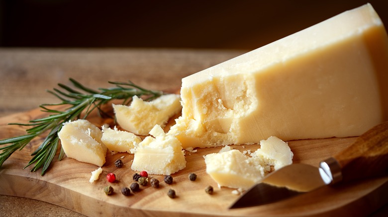 Pieces of Parmigiano Reggiano with pepper and herb