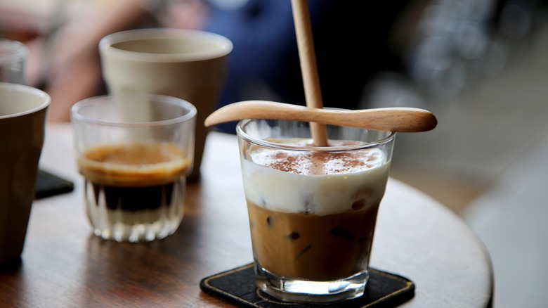 Cà phê muối, an iced Vietnamese coffee, on a wooden table.