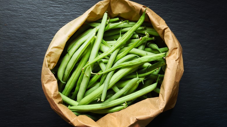 raw green beans in a paper bag