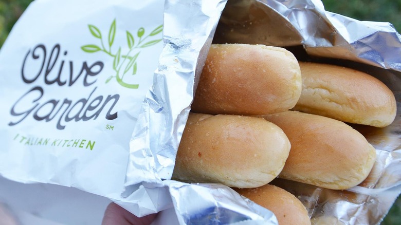 Olive Garden breadsticks in branded takeout bag closeup