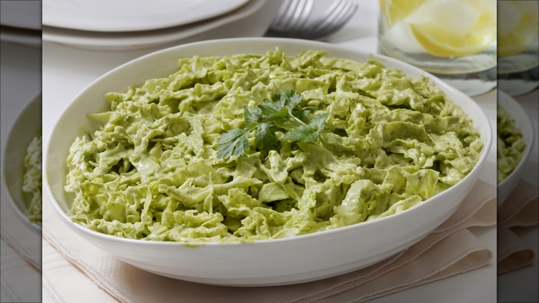 closeup shot of chopped cabbage coated with green goddess dressing