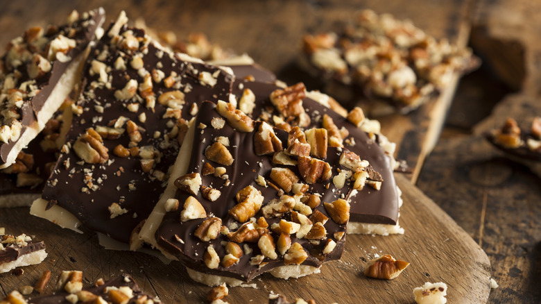 Toffee topped with chocolate and pecans.