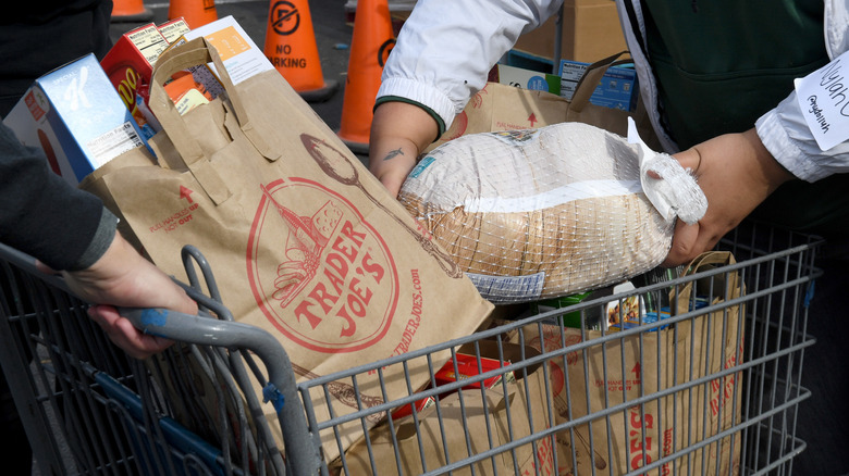 full shopping cart with trader joe's bags