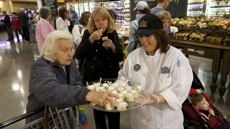 woman getting a sample at whole foods