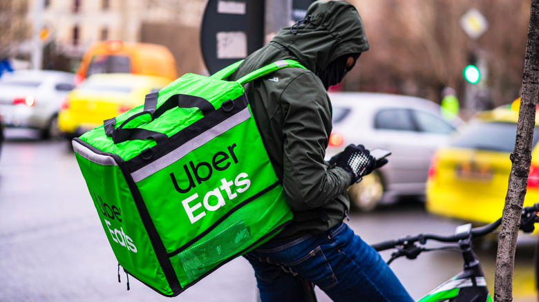 Uber Eats biker with Uber Eats bag delivering food