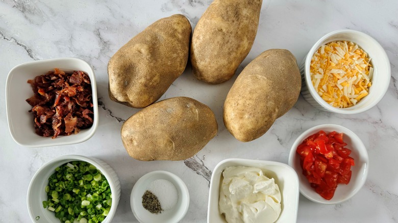 raw potatoes with assorted toppings