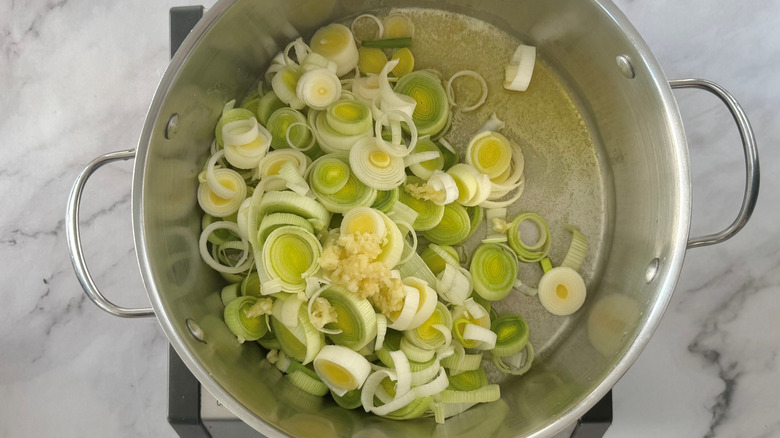 Chopped leeks and garlic in a metal pot