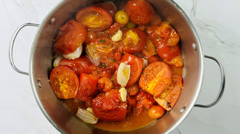 tomatoes, shallots, and garlic in a metal pot