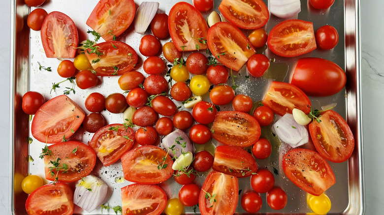 Tomatoes, shallots, and garlic in a baking pan