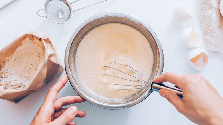 mixing together pancake batter in bowl