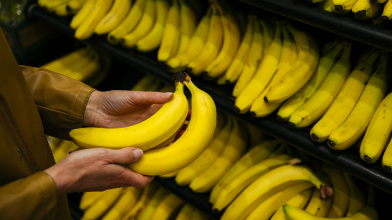 Bananas in grocery store, in someone's hands