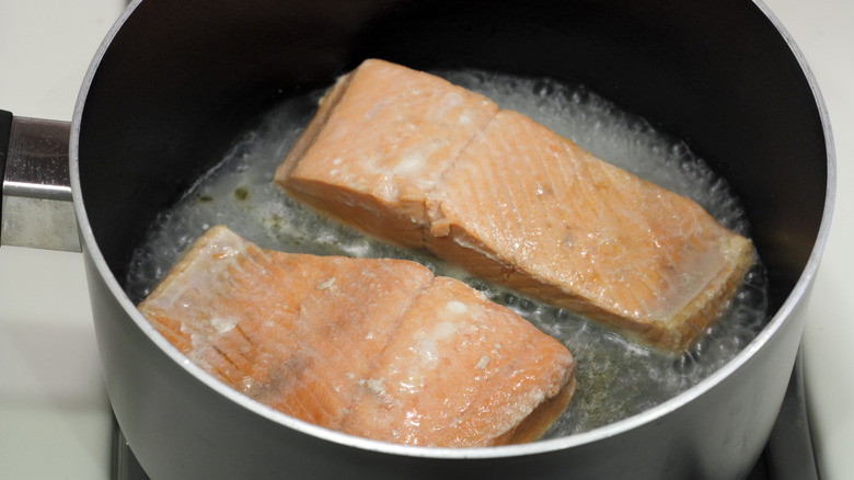 Salmon filets poaching in water