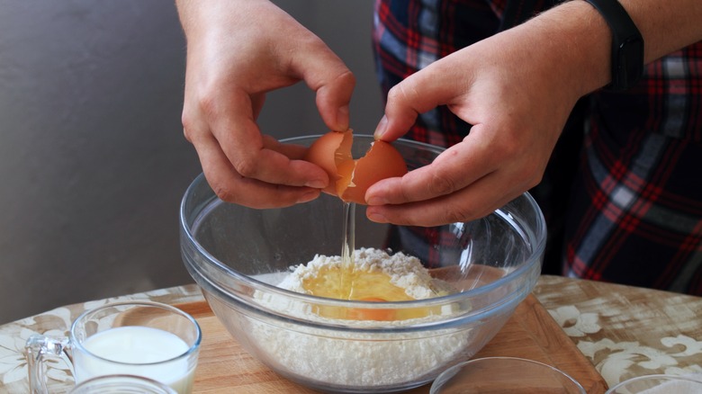 cracking egg into mixing bowl