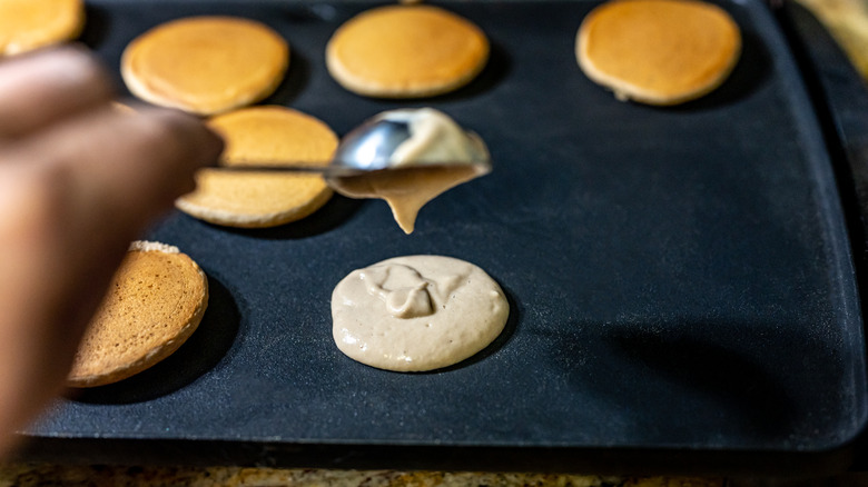 scooping pancake onto griddle