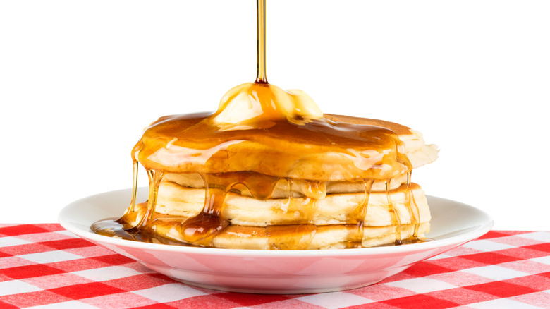 pouring syrup on pancakes