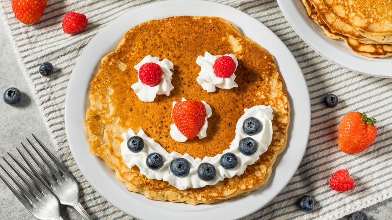 smiley face pancake with whipped cream