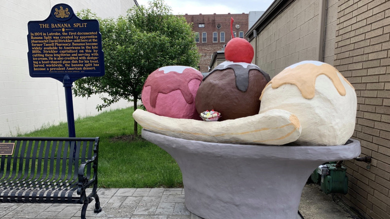 Statue in the shape of a banana split commemorating the site where Strickler first made a banana split