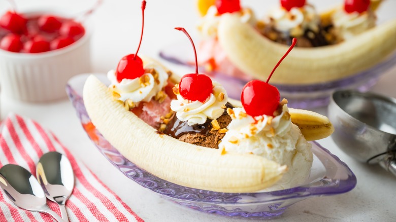 Banana split with cherries, whipped cream, and nuts