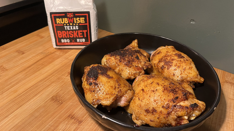 Four cooked chicken thighs with Rubwise Texas Brisket BBQ Rub sitting in a plate