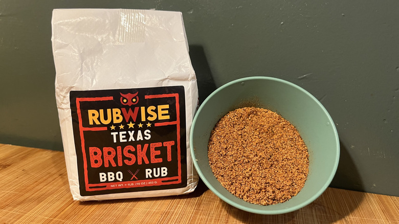 A bag of Rubwise Texas Brisket BBQ Rub next to a small bowl of seasoning