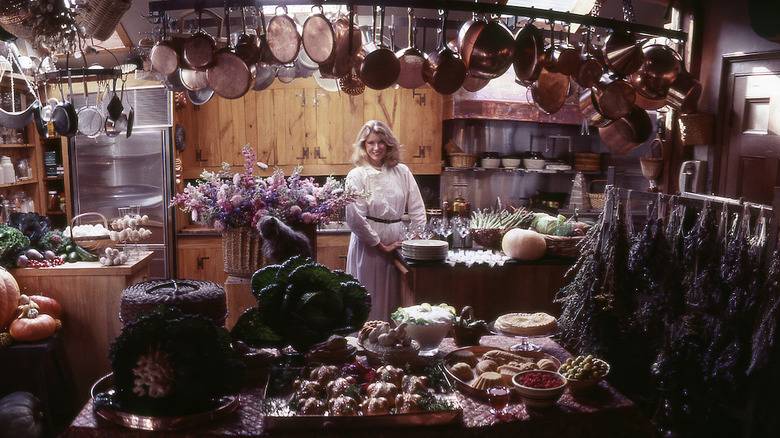 Martha Stewart is at home in her Turkey Hill kitchen with a large amount of vegetables and flowersworking on her catering business in a still from the Netflix documentary "Martha."