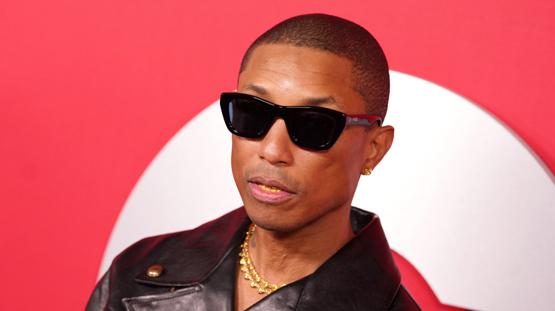 Pharrell Williams wearing shades and a black leather jacket