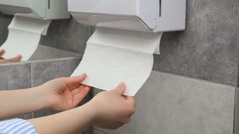 Person taking a paper towel from dispenser