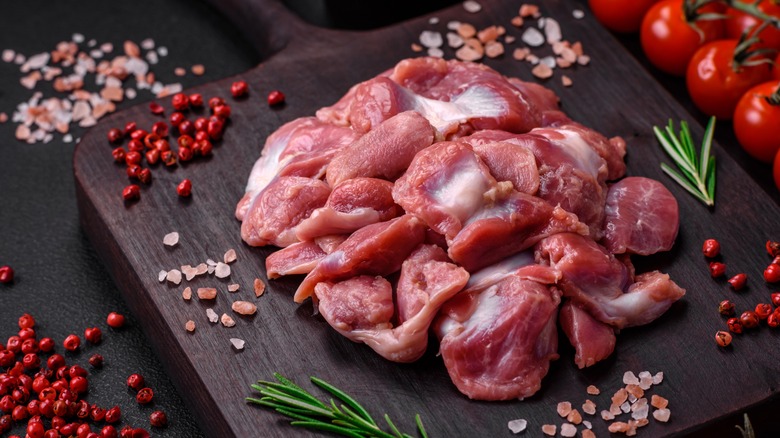 Turkey giblets on dark board with rosemary